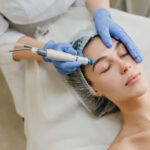 view from rejuvenation beautiful woman enjoying cosmetology procedures beauty salon dermatology hands blue glows healthcare therapy botox 1 1024x683 1