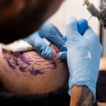 high angle talented tattoo artist doing his job 1290x750 1 300x200 1