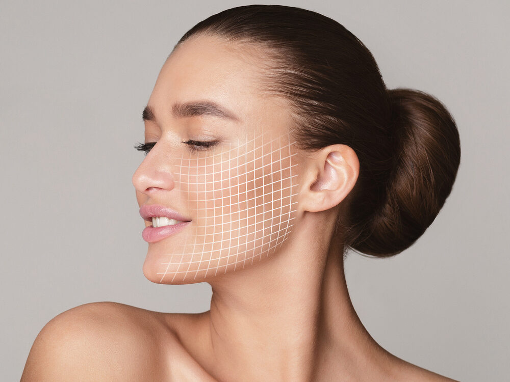 Woman with closed eyes and a digital grid overlay on her face illustrating whether does Morpheus8 hurt during RF microneedling skin tightening treatment