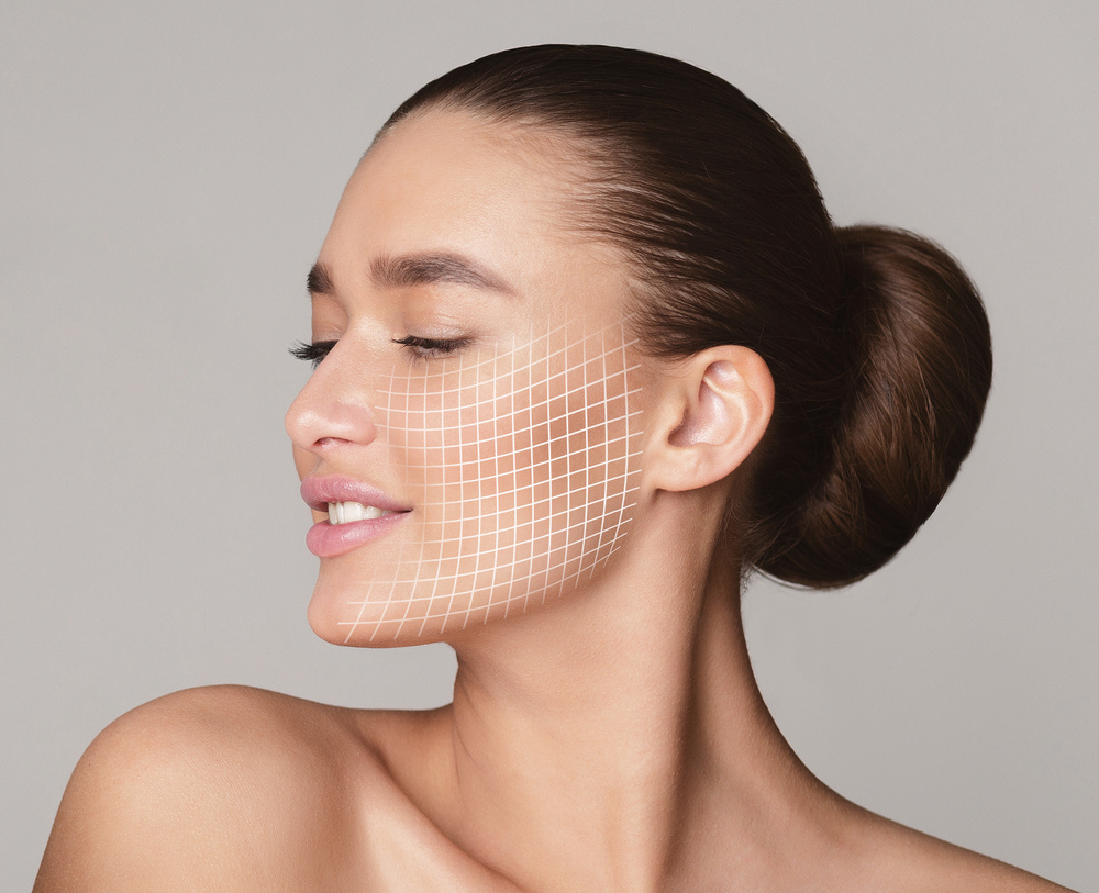 Woman with closed eyes and a digital grid overlay on her face illustrating whether does Morpheus8 hurt during RF microneedling skin tightening treatment