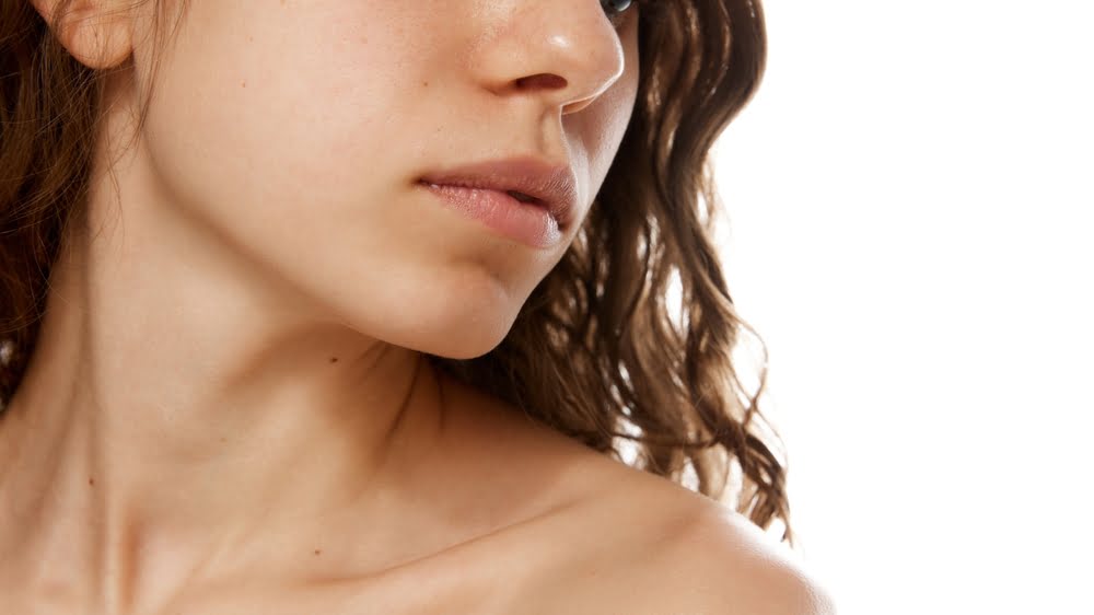 Side profile of a woman with a smooth, defined jawline and clean neck contour representing the results of Quantum RF neck and jawline skin tightening treatment